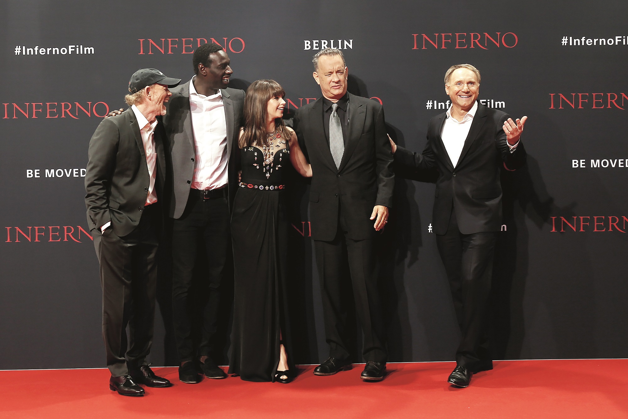 BERLIN, GERMANY - OCTOBER 10:  (L-R) US actor Ron Howard, french actor Omar Sy, british actress Felicity Jones, US actor Tom Hanks and US author Dan Brown attend the German premiere of the film 'INFERNO' at Sony Centre on October 10, 2016 in Berlin, Germany. (Photo by Isa Foltin/Getty Images for Sony Pictures)